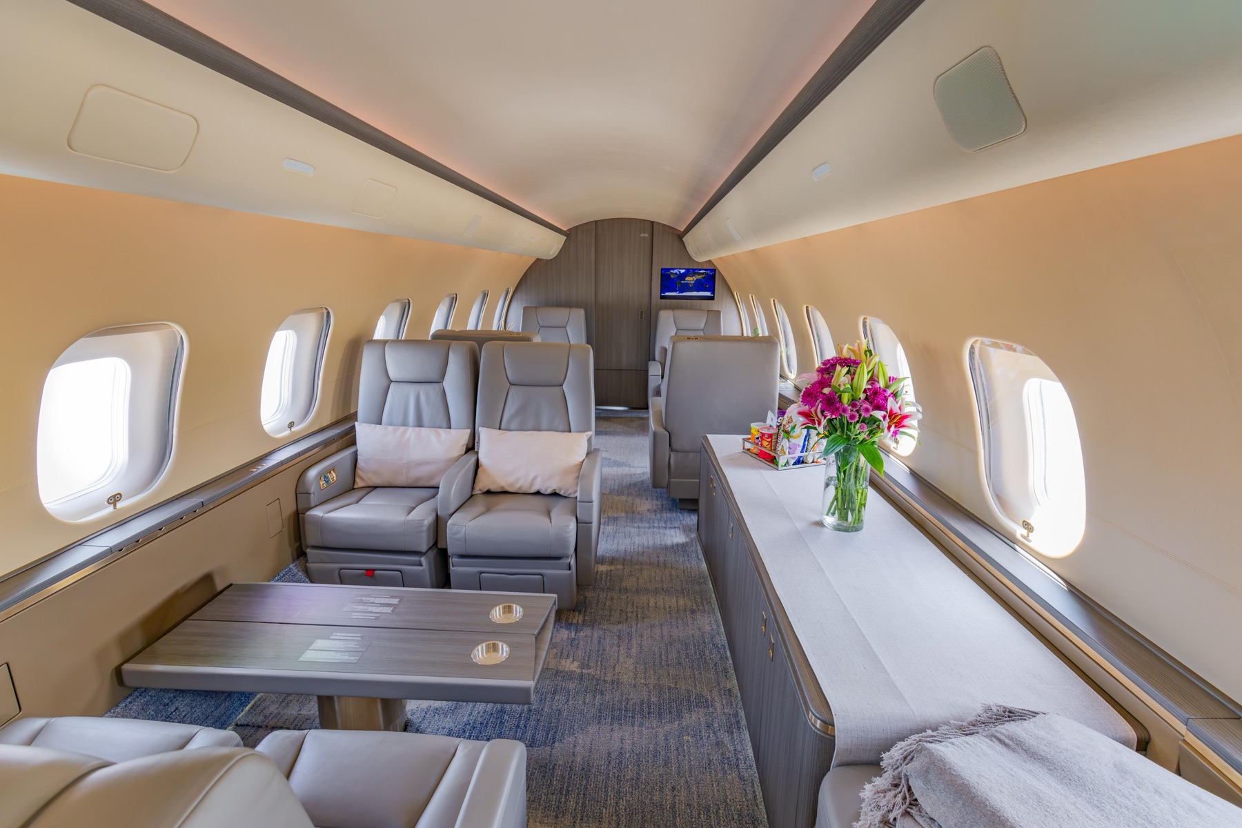 Global 5000 cabin looking forward with club seating and dining group